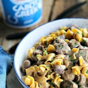 Instant Pot Garlic Beef Stroganoff: creamy, extra garlicky, mushroom and onion gravy enrobing tender beef cubes, with perfect pasta all cooked together in the Instant Pot. This has to be one of the most simple, crave-worthy comfort foods ever to be adapted to the world of electric pressure cookers.