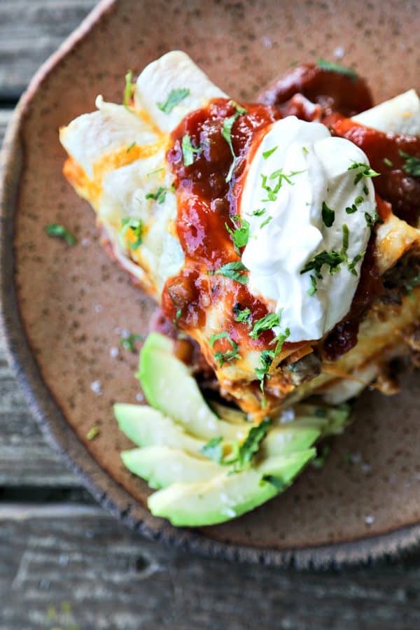 Overnight Taco Breakfast Enchiladas are the happy marriage of breakfast egg bakes, taco flavours, and enchiladas all together in one convenient, delicious package that is assembled the night before it bakes, leaving you to dream of satisfying, hearty breakfasts with no more work than sliding a pan in the oven!