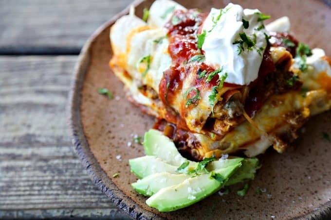 Overnight Taco Breakfast Enchiladas are the happy marriage of breakfast egg bakes, taco flavours, and enchiladas all together in one convenient, delicious package that is assembled the night before it bakes, leaving you to dream of satisfying, hearty breakfasts with no more work than sliding a pan in the oven!