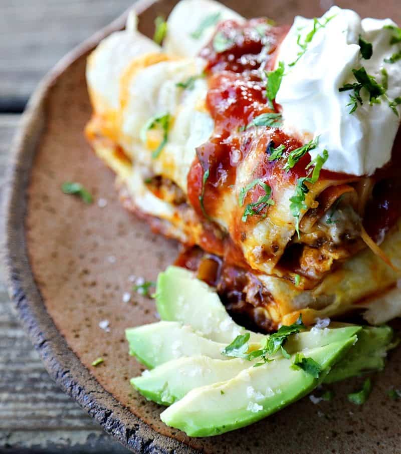 Overnight Taco Breakfast Enchiladas are the happy marriage of breakfast egg bakes, taco flavours, and enchiladas all together in one convenient, delicious package that is assembled the night before it bakes, leaving you to dream of satisfying, hearty breakfasts with no more work than sliding a pan in the oven!