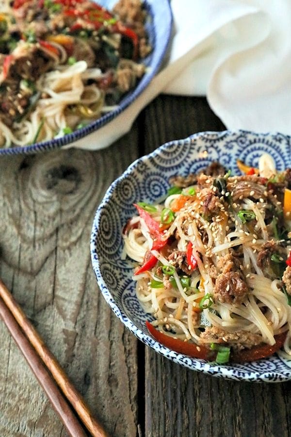 Easy Garlic Ginger Crispy Pork Noodles are going to be your new favourite dinner. Crazy simple. Crazier delicious. And easy on your pocketbook to boot. This delicious meal-in-one whips up in less than 30 minutes.