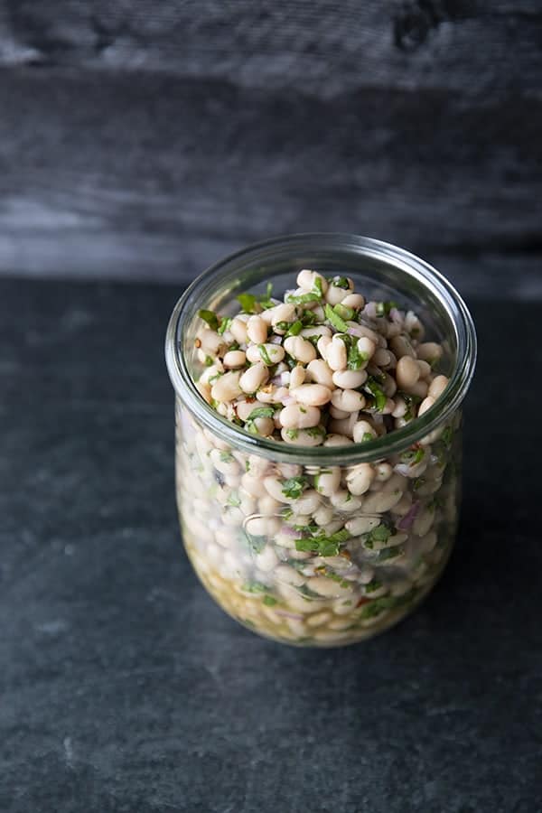 Full of fresh herb flavors, White Bean Salad comes together in a breeze. Made with canned or home cooked white beans, abundant fresh herbs, and a simple vinaigrette dressing, this salad is delicious as a light lunch on its own or as a side dish with all your favorite entrees. 