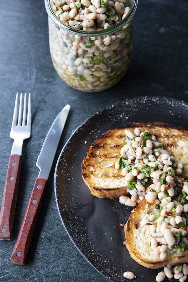 Full of fresh herb flavors, White Bean Salad comes together in a breeze. Made with canned or home cooked white beans, abundant fresh herbs, and a simple vinaigrette dressing, this salad is delicious as a light lunch on its own or as a side dish with all your favorite entrees. 