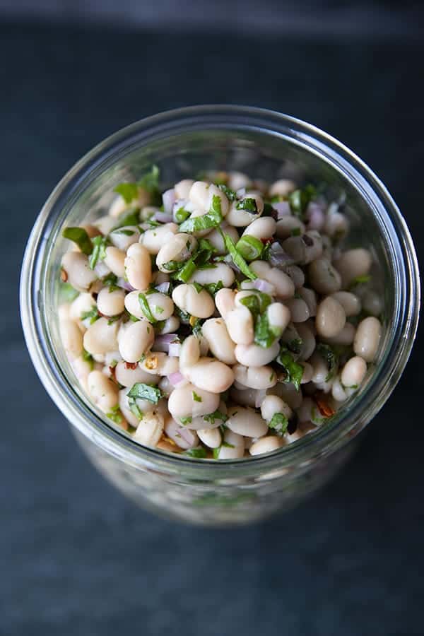 Full of fresh herb flavors, White Bean Salad comes together in a breeze. Made with canned or home cooked white beans, abundant fresh herbs, and a simple vinaigrette dressing, this salad is delicious as a light lunch on its own or as a side dish with all your favorite entrees. 