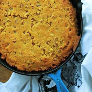 Toasty Ham Cheddar Onion Cornbread is buttermilk cornbread bursting with golden brown ham cubes, caramelized onions, and pockets of melted Cheddar cheese.