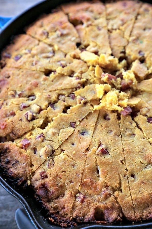 Toasty Ham Cheddar Onion Cornbread is buttermilk cornbread bursting with golden brown ham cubes, caramelized onions, and pockets of melted Cheddar cheese.