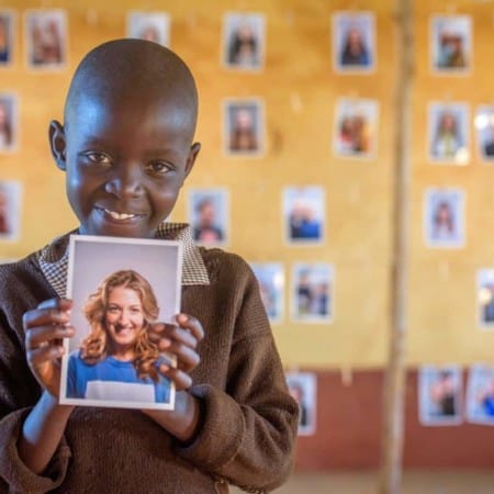 A Child looking at potential sponsors to choose through World Vision's Chosen program.